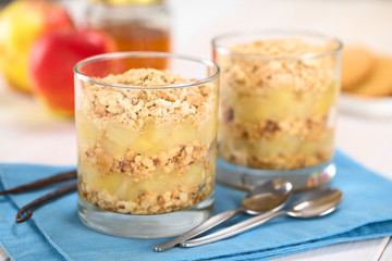 Simple no-bake Danish apple cake called Aeblekage made of stewed apple and vanilla cookie crumbs served in glass (Selective Focus, Focus on the front of the upper two layers)