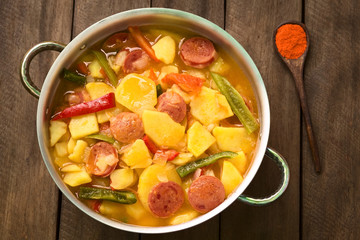 Hungarian dish called Paprikas Krumpli (Potato with Paprika), a stew made of potato, onion, pepper, tomato, sausage (Selective Focus, Focus in the middle of the dish)