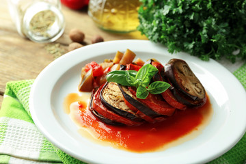 Ratatouille on plate, on table background