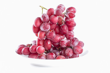  fresh and sweet red grapes on dish