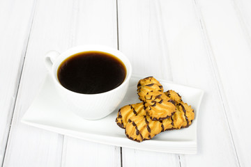 cup of coffee and delicious cakes on a white background