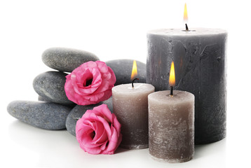 Obraz na płótnie Canvas Aroma candles with pebbles and flower isolated on white background