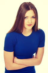 Obraz premium Teen woman suffering pain in her tummy.