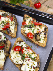delicious bruschetta with tomatoes, cheese and mushrooms