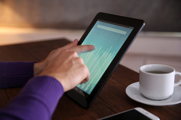 Young man using his tablet-pc, close up
