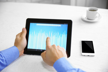 Young businessman using his tablet-pc, close up