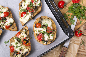 delicious bruschetta with tomatoes, cheese and mushrooms