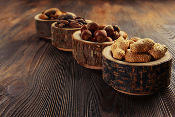 Assortment of tasty nuts on wooden background