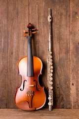 violin and flute in vintage style on wood background
