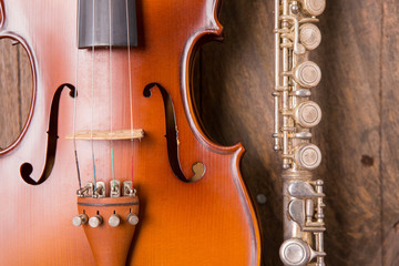 violin and flute in vintage style on wood background
