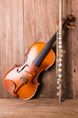 Fototapeta na wymiar violin and flute in vintage style on wood background