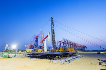 landscape of oilfield with pump units in blue sky