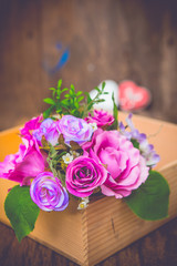 Vintage rose bouquet on wood background