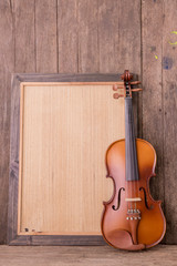 Obraz na płótnie Canvas violin in vintage style on wood background