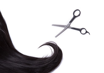Black shiny hair strand with professional scissors