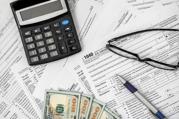 Naklejka na ściany i meble Tax form with pen, calculator, glasses and money