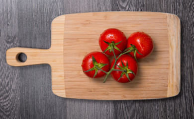 Fresh tomatoes on chopping board