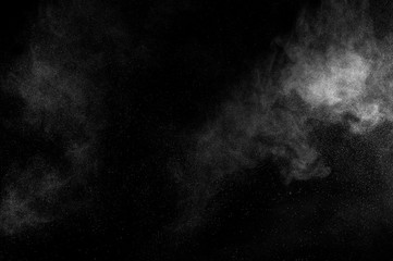 abstract white dust explosion  on a black background. abstract white powder. design elements....