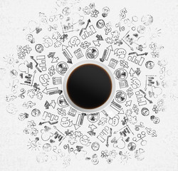 Top view of a coffee cup and a lot of business icons and charts on the white surface.
