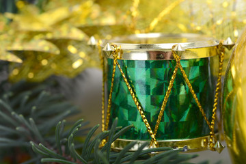 Christmas background with drums, green eve tree branch, golden new year decoration