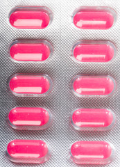 Pink tablet pills in blister