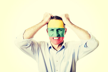 Mature man with Lithuania flag on face.