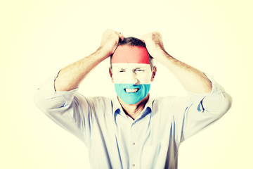 Mature man with Luksemburg flag on face.