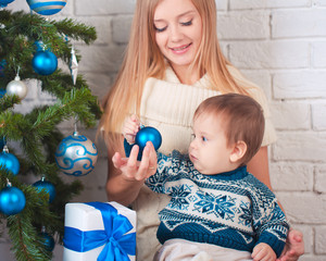 Mother with son near christmas tree