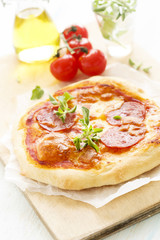 Pizza with salami and oregano