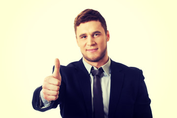 Happy smiling businessman with thumbs up.