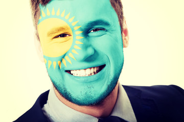 Happy man with Kazakhstan flag on face.