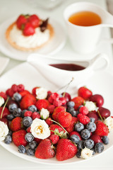 Yummy breakfast - sweet cake with tea and berries - health and non diet concept
