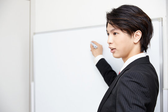 プレゼンテーションをするスーツの男性