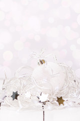 Magic xmas card. Beautiful glitter white christmas ball and decorations. Selective focus