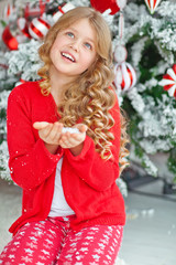 happy girl play with snow near christmas tree