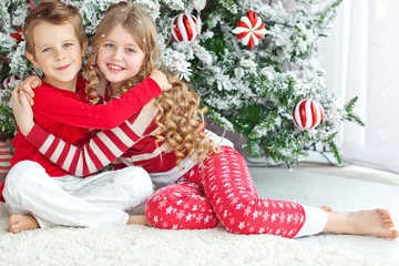 kids near the christmas tree