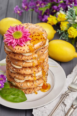 Still life of bananas and biscuits with honey.
