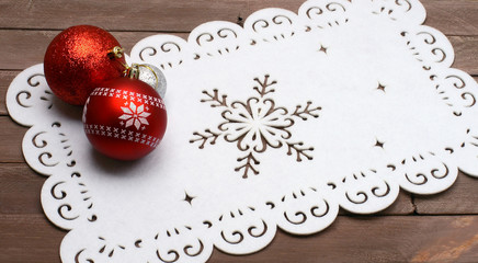 christmas balls on a napkin on wooden background