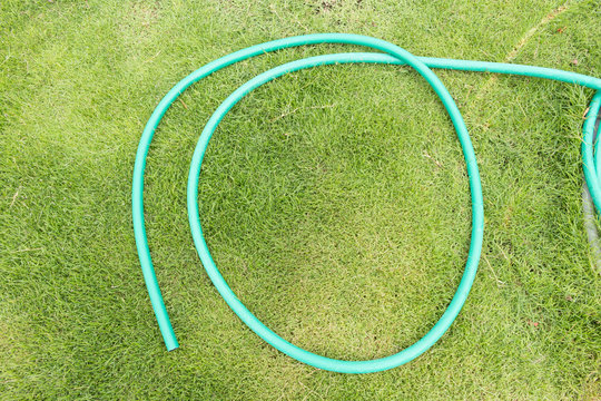 Green Garden Hose On Green Grass