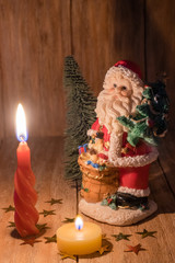 Santa Claus with candle and Christmas tree
