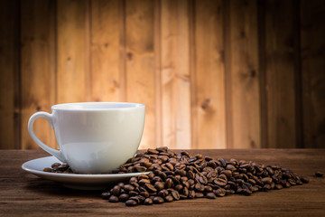 still life with coffee beans and old coffee mill on the wooden background
