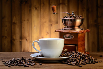 still life with coffee beans and old coffee mill on the wooden background