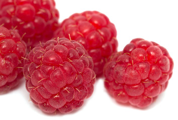 ripe raspberries on a white background