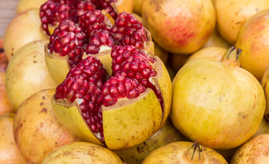 Closeup many pomegranete  fruit in market