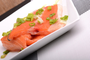 Salted salmon fillet with parsley leaf on the white bowl