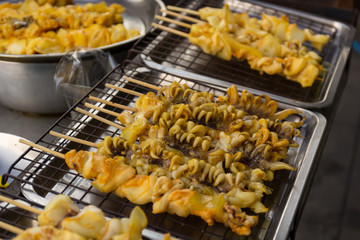 Product of squid on tray in market by street