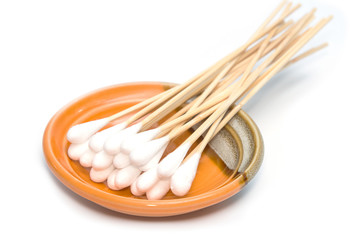 Group of cotton sticks in plate on white background