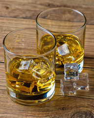 Two glasses of whiskey with ice,selective focus.