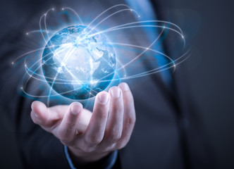 Businessman holding planet Earth in palm