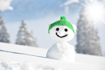 Snowman against Alpine scenery